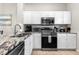 Modern kitchen with stainless steel appliances and granite countertops at 8558 Crystal Cove Loop, Kissimmee, FL 34747