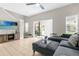 Living room with large TV, sectional sofa and patio access at 8558 Crystal Cove Loop, Kissimmee, FL 34747