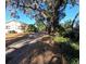 Long driveway leading to a ranch style home with mature trees at 9000 Ogilvie Dr, Orlando, FL 32819