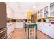 Bright kitchen featuring white cabinets and a green island at 9000 Ogilvie Dr, Orlando, FL 32819