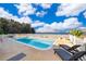 Inviting pool with lake view and lounge chairs at 9000 Ogilvie Dr, Orlando, FL 32819