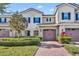 Two-story townhome with stone accents and a two-car garage at 9787 Winnington St, Orlando, FL 32832