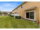 Private backyard with grassy area and sliding glass door access at 10125 Shadow Leaf Ct, Orlando, FL 32825