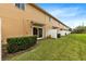 Backyard with grassy lawn, and townhome patio with privacy fence at 10125 Shadow Leaf Ct, Orlando, FL 32825