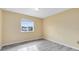 Well-lit bedroom with wood-look floors and a window at 10125 Shadow Leaf Ct, Orlando, FL 32825