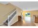 Bright entryway with staircase, hardwood floors, and view into living area at 10125 Shadow Leaf Ct, Orlando, FL 32825