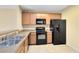 Well-equipped kitchen with stainless steel sink and light wood cabinets at 10125 Shadow Leaf Ct, Orlando, FL 32825