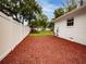 Landscaped backyard with red mulch and privacy fence at 105 N Hillside Ave, Orlando, FL 32803