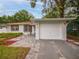 White garage with paver driveway and landscaping at 105 N Hillside Ave, Orlando, FL 32803