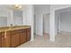 Bathroom with granite countertop, large mirror and access to bedrooms at 11113 Scenic Vista Dr, Clermont, FL 34711