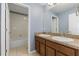 Bathroom with double vanity, a large mirror, and a bathtub at 11113 Scenic Vista Dr, Clermont, FL 34711