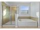 Bathroom with a large soaking tub, walk-in shower, and window at 11113 Scenic Vista Dr, Clermont, FL 34711