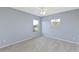 Spacious bedroom with light blue walls and carpet flooring at 11113 Scenic Vista Dr, Clermont, FL 34711