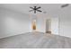Bright bedroom with grey carpet, ceiling fan and access to bathroom at 11113 Scenic Vista Dr, Clermont, FL 34711