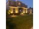 Two-story house exterior with lighting at night at 11113 Scenic Vista Dr, Clermont, FL 34711