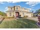 Two-story house with a red door, landscaping, and a paved driveway at 11113 Scenic Vista Dr, Clermont, FL 34711