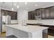 Modern kitchen with dark cabinetry and a large island at 11113 Scenic Vista Dr, Clermont, FL 34711