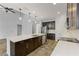 Kitchen with large island, stainless steel appliances, and dark cabinets at 11113 Scenic Vista Dr, Clermont, FL 34711