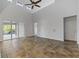 Living room with high ceilings, tile floors, and sliding doors to patio at 11113 Scenic Vista Dr, Clermont, FL 34711