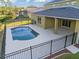 Refreshing kidney-shaped pool with covered patio and fenced backyard at 11113 Scenic Vista Dr, Clermont, FL 34711