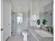Bathroom with gray vanity, glass shower and granite countertop at 13714 Fresh Ivy St, Winter Garden, FL 34787
