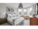 Bright bedroom with wood-look floors and large windows at 13714 Fresh Ivy St, Winter Garden, FL 34787