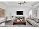 Spacious living area with built-in shelving and a large TV at 13714 Fresh Ivy St, Winter Garden, FL 34787