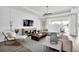 Living room boasts wood floors, large TV, and comfy seating at 13714 Fresh Ivy St, Winter Garden, FL 34787