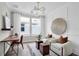 Home office with wood desk and white accent chairs at 13714 Fresh Ivy St, Winter Garden, FL 34787