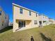 Rear view of a two story house with a patio and grassy backyard at 14515 Crestavista Ave, Clermont, FL 34714