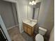 Modern half bath featuring a vanity and toilet at 14521 Crestavista Ave, Clermont, FL 34714