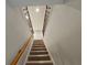 Elegant staircase with wood railing and carpet at 14521 Crestavista Ave, Clermont, FL 34714