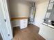 Laundry room with wood countertop, white cabinets, and water heater at 1588 Clearfield St, Deltona, FL 32725