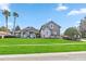 House exterior with stone accents, palm trees, and a manicured lawn at 16908 Florence View Dr, Montverde, FL 34756