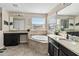 Bathroom with a large soaking tub, double sinks, and granite countertops at 1942 J Lawson Blvd, Orlando, FL 32824