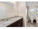 Well-lit bathroom with dual sinks and granite countertops at 1942 J Lawson Blvd, Orlando, FL 32824
