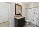 Bathroom with granite vanity and floral shower curtain at 1942 J Lawson Blvd, Orlando, FL 32824