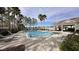 Inviting community pool with lounge chairs and a shaded seating area at 1942 J Lawson Blvd, Orlando, FL 32824