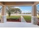 Covered front porch overlooks a landscaped lawn and tranquil lake at 1942 J Lawson Blvd, Orlando, FL 32824