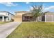Two-story house with a screened patio and driveway at 1942 J Lawson Blvd, Orlando, FL 32824