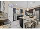 Modern kitchen with dark cabinets, granite countertops, and island at 1942 J Lawson Blvd, Orlando, FL 32824