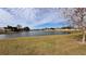 Scenic lakefront view with grassy area and mature trees at 1942 J Lawson Blvd, Orlando, FL 32824