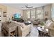 Living room with sofas, chairs, coffee table, and large windows at 1942 J Lawson Blvd, Orlando, FL 32824