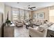 Spacious living room with beige sofas, a coffee table, and large windows at 1942 J Lawson Blvd, Orlando, FL 32824