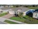 Aerial view of house with two-car garage and yard at 2249 Palmetum Loop, Apopka, FL 32712