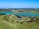 Breathtaking aerial view of park featuring a stage, walking paths, picturesque lake, and recreational area at 2249 Palmetum Loop, Apopka, FL 32712