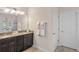 Bathroom featuring double sink vanity with granite countertops and dark cabinets at 2249 Palmetum Loop, Apopka, FL 32712