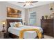 Cozy bedroom with natural light, dresser, and a comfortable bed with lamps at 2249 Palmetum Loop, Apopka, FL 32712