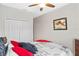 This is an interior view of the bedroom featuring a ceiling fan, bed, and closet at 2249 Palmetum Loop, Apopka, FL 32712