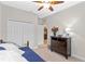 Bright bedroom features a ceiling fan, double closet, and view to the ensuite bathroom at 2249 Palmetum Loop, Apopka, FL 32712